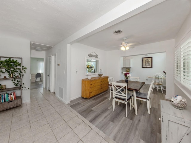 dining area featuring light wood-type flooring, baseboards, visible vents, and a ceiling fan