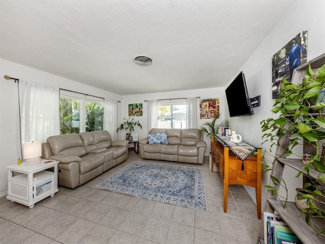 living room with visible vents and light tile patterned flooring