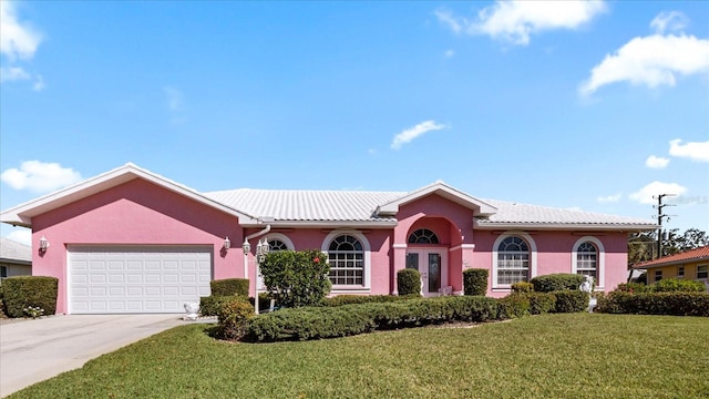 single story home with a garage, concrete driveway, stucco siding, a tiled roof, and a front yard