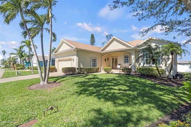 view of front of property featuring a garage, driveway, a front yard, and stucco siding