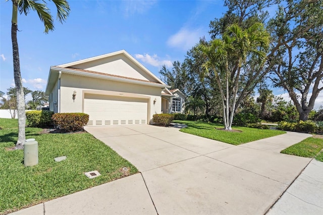 ranch-style home with concrete driveway, a front yard, an attached garage, and stucco siding