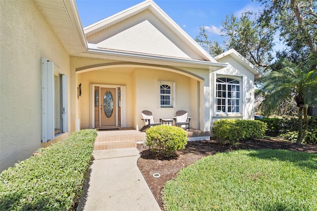 entrance to property with stucco siding