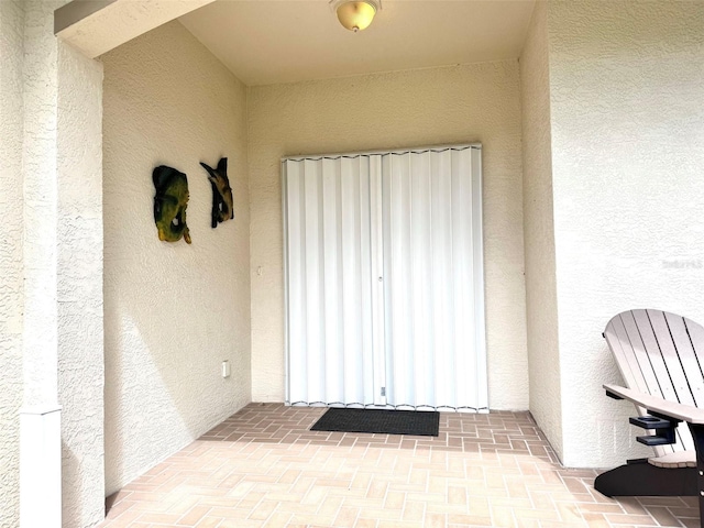 entrance to property with stucco siding