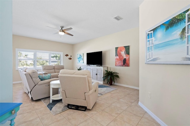 living room featuring baseboards, visible vents, a ceiling fan, and light tile patterned flooring