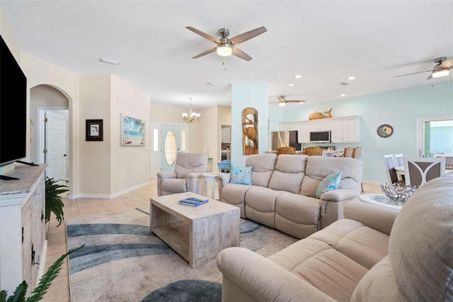 living area with light tile patterned floors, recessed lighting, visible vents, baseboards, and ceiling fan with notable chandelier