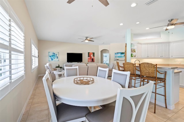 dining space with a ceiling fan, arched walkways, and visible vents