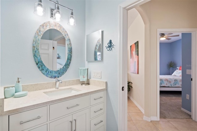 bathroom with ensuite bathroom, baseboards, vanity, and tile patterned floors