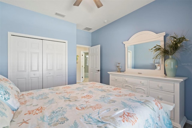 bedroom with lofted ceiling, a ceiling fan, visible vents, and a closet