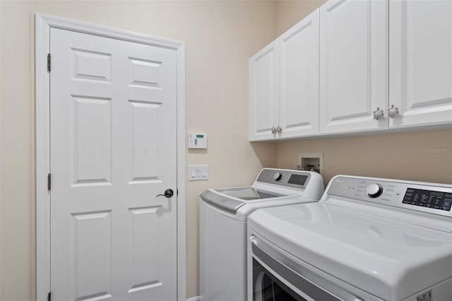 laundry room featuring cabinet space and washing machine and dryer