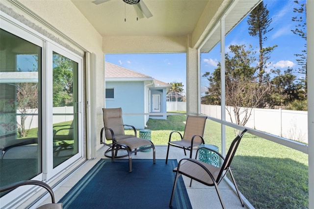 sunroom / solarium featuring a healthy amount of sunlight and ceiling fan