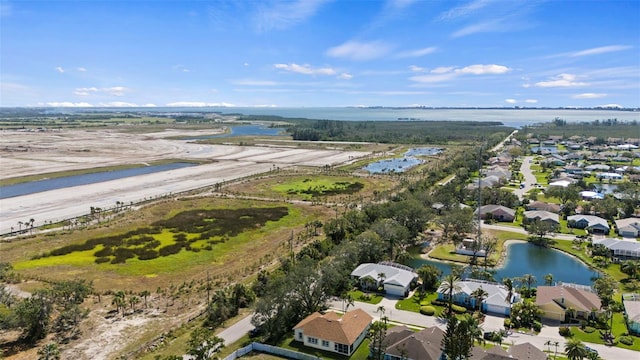 drone / aerial view featuring a residential view and a water view