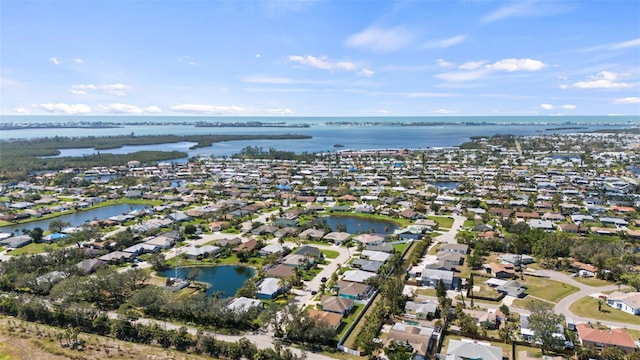 birds eye view of property featuring a water view and a residential view