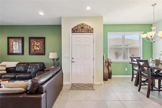 living area featuring recessed lighting, baseboards, a notable chandelier, and light tile patterned flooring