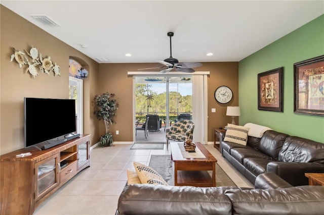 living room featuring light tile patterned flooring, recessed lighting, a ceiling fan, visible vents, and baseboards