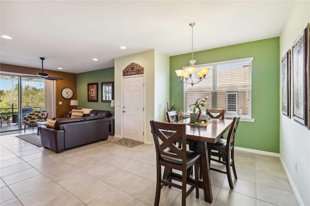 dining space with ceiling fan with notable chandelier, recessed lighting, baseboards, and light tile patterned floors