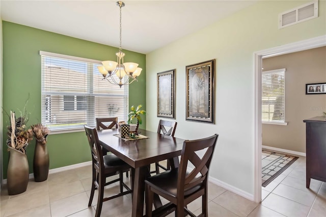 dining space featuring a healthy amount of sunlight, an inviting chandelier, baseboards, and visible vents