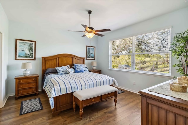 bedroom featuring ceiling fan, dark wood finished floors, and baseboards