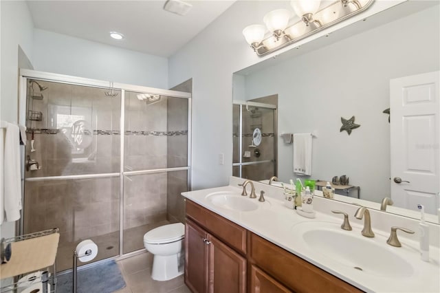 bathroom featuring tile patterned flooring, a sink, a shower stall, and toilet