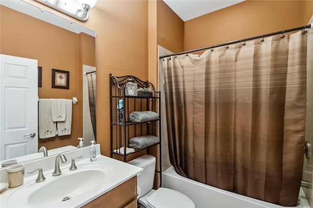 bathroom with shower / tub combo, vanity, and toilet