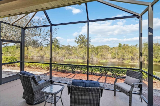 exterior space featuring glass enclosure and a water view