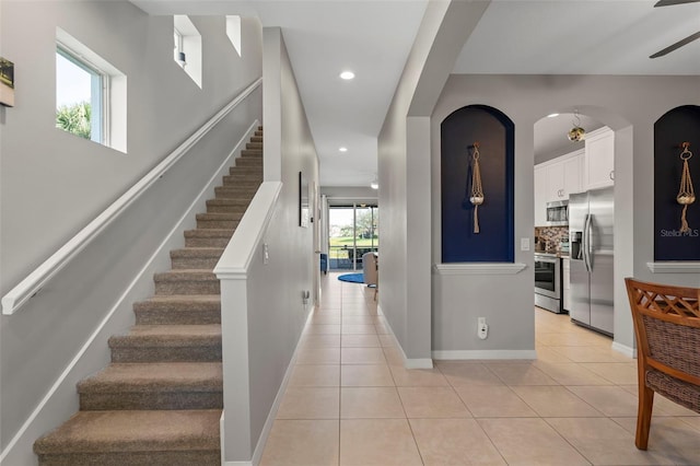 1050 Jonah Dr, North Port, FL 34289 - entryway with light tile patterned floors, stairs, baseboards, and recessed lighting
