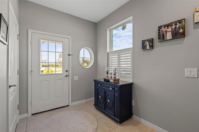 1050 Jonah Dr, North Port, FL 34289 - doorway with plenty of natural light, baseboards, and light tile patterned floors