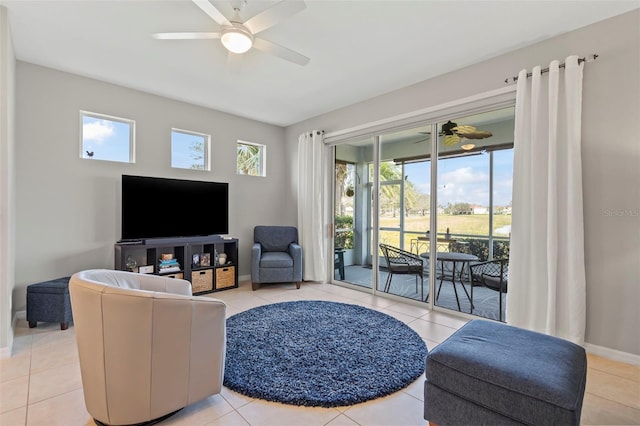 1050 Jonah Dr, North Port, FL 34289 - living area featuring light tile patterned floors, baseboards, and a ceiling fan