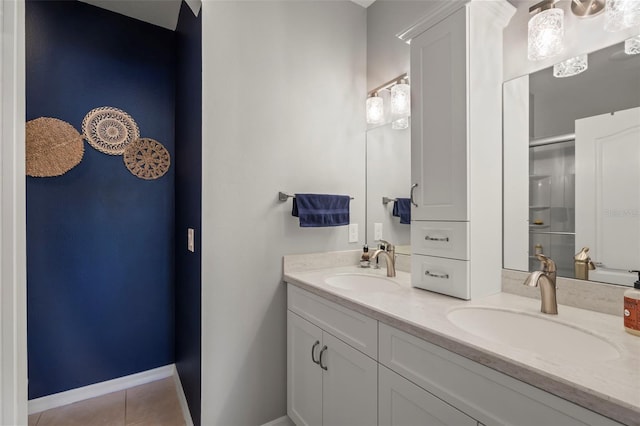 1050 Jonah Dr, North Port, FL 34289 - bathroom featuring double vanity, a stall shower, tile patterned flooring, and a sink
