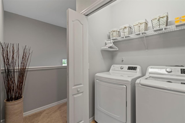 1050 Jonah Dr, North Port, FL 34289 - laundry room featuring baseboards, laundry area, washer and clothes dryer, and light colored carpet
