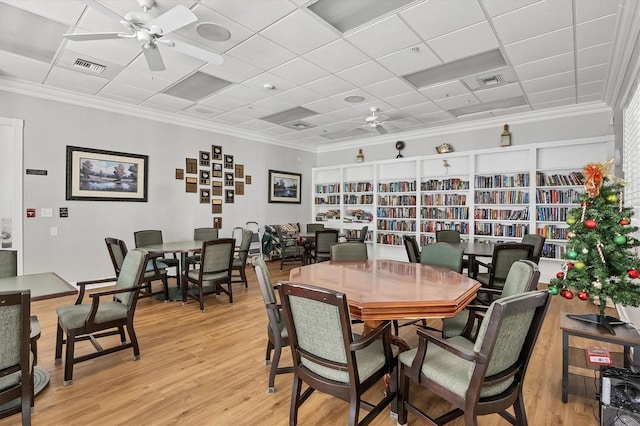 1050 Jonah Dr, North Port, FL 34289 - dining room featuring ornamental molding, light wood-style flooring, visible vents, and a ceiling fan