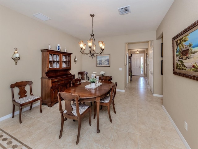 dining room featuring a chandelier, visible vents, baseboards, and light tile patterned floors