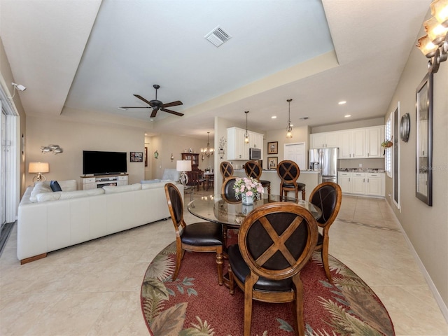 dining space featuring light tile patterned floors, baseboards, visible vents, a raised ceiling, and recessed lighting