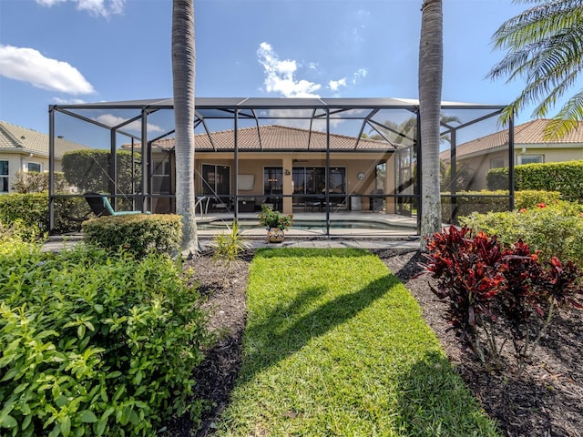 rear view of property featuring a patio area, a tile roof, glass enclosure, and an outdoor pool