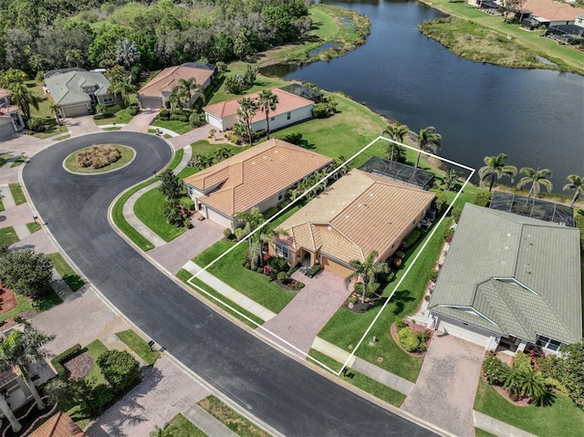 drone / aerial view with a water view and a residential view