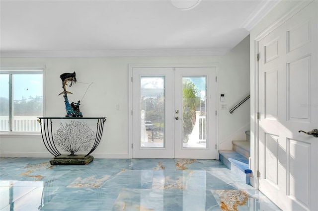 entryway featuring ornamental molding, a wealth of natural light, french doors, and stairway