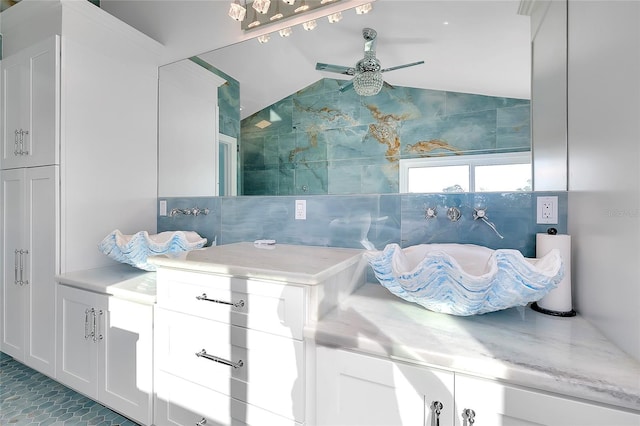 bathroom with a ceiling fan and lofted ceiling