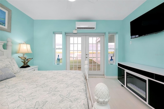 bedroom featuring access to outside, french doors, and a wall mounted AC