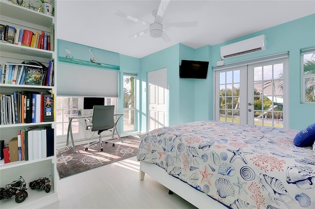 bedroom featuring access to exterior, french doors, a wall unit AC, and ceiling fan