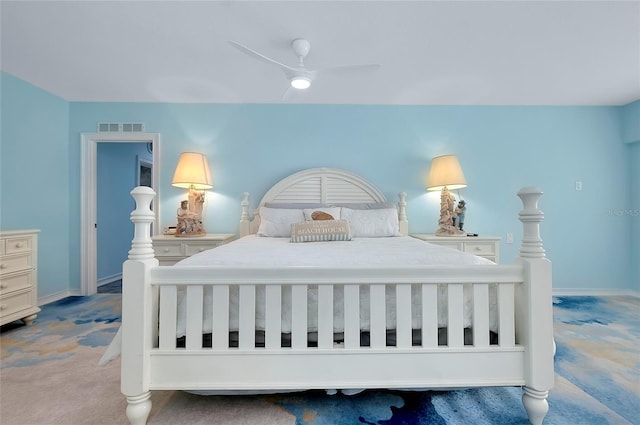 carpeted bedroom featuring ceiling fan, visible vents, and baseboards