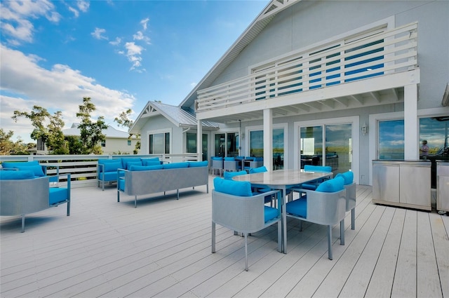 wooden deck with outdoor dining space and an outdoor hangout area