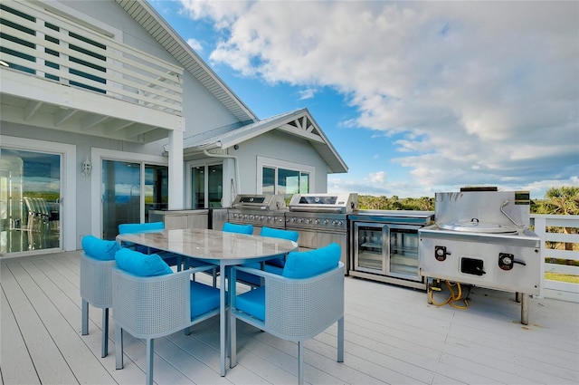 wooden deck featuring outdoor dining area and area for grilling