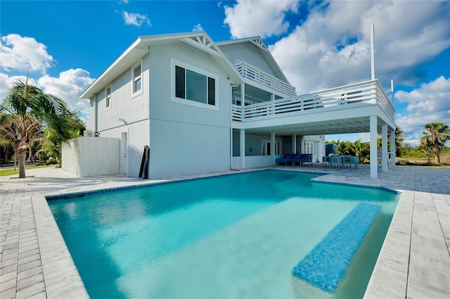 back of house featuring a patio area, an outdoor pool, fence, and stucco siding