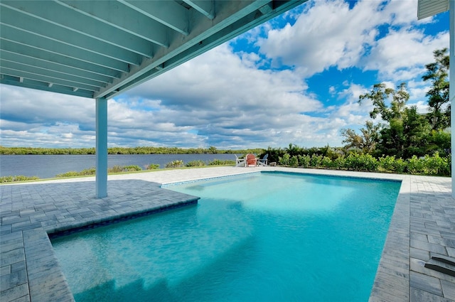 outdoor pool with a patio area and a water view