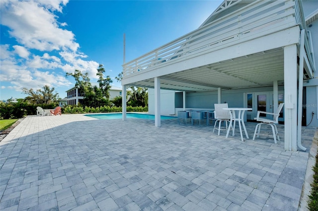 pool with outdoor dining area and a patio area