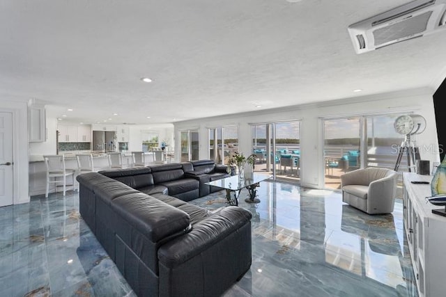 living area featuring ornamental molding, marble finish floor, visible vents, and a textured ceiling