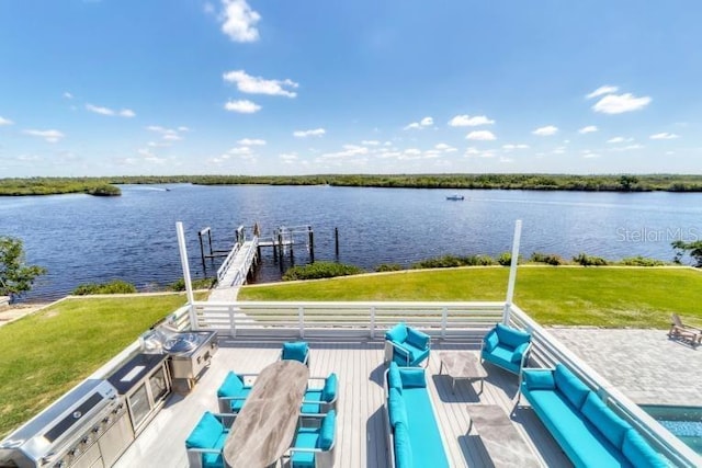 view of dock with a lawn, a water view, and boat lift