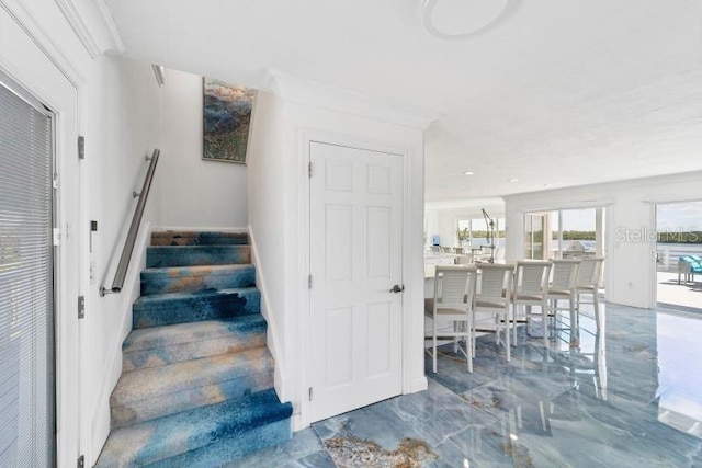 staircase featuring marble finish floor