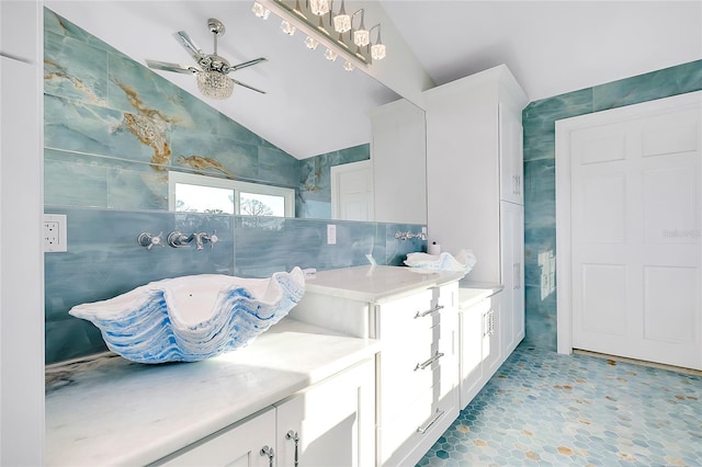 bathroom featuring lofted ceiling, ceiling fan, and tile walls