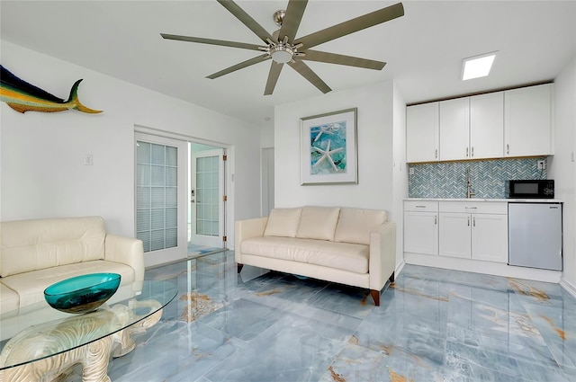 living room with marble finish floor and ceiling fan