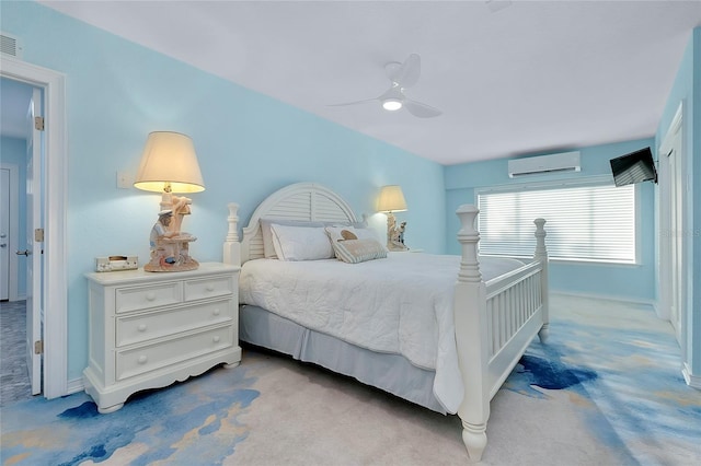 bedroom featuring carpet, a wall mounted air conditioner, and a ceiling fan